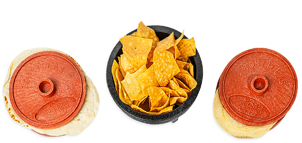 Two tortilla presses and a bowl of tortilla chips