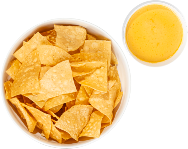 A basket of tortilla chips with a bowl of chile con queso