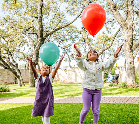 Children playing with balloons at a celebration