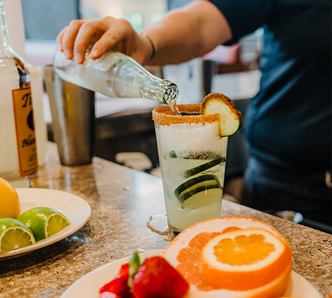 A bartender pouring a drink