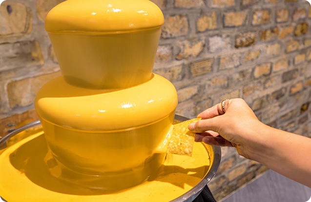 A queso fountain at an Alamo Cafe catered event