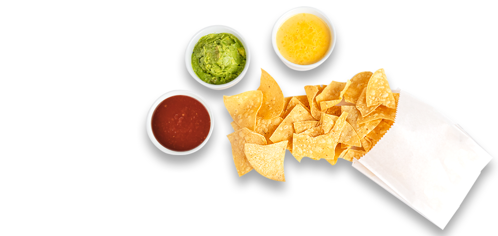 Tortilla chips spilling from a bag beside bowls of salsa, queso and guacamole